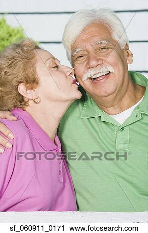 Senior Hispanic woman kissing husband’s cheek View Large Photo Image Stock Image - Senior Hispanic woman kissing husband’s cheek. Fotosearch