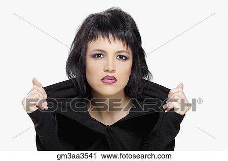 Studio shot of young woman pulling out collar of shirt View Large Photo Image Stock Image - Studio shot of young woman pulling out collar of shirt. Fotosearch