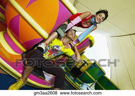 Teenage Hispanic couple sitting in teacup carnival ride View Large Photo Image Stock Photo - Teenage Hispanic couple sitting in teacup carnival ride. Fotosearch