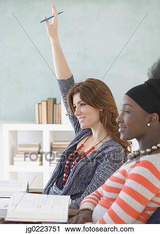 Stock Image - Two female college students in class. Fotosearch