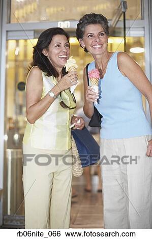 Two Hispanic women eating ice cream cones View Large Photo Image Stock Photograph - Two Hispanic women eating ice cream cones. Fotosearch
