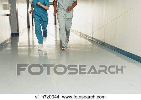 Two nurses running down corridor in hospital View Large Photo Image Picture - Two nurses running down corridor in hospital. Fotosearch