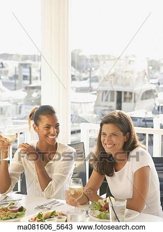 Two women eating in marina restaurant View Large Photo Image Stock Image - Two women eating in marina restaurant. Fotosearch