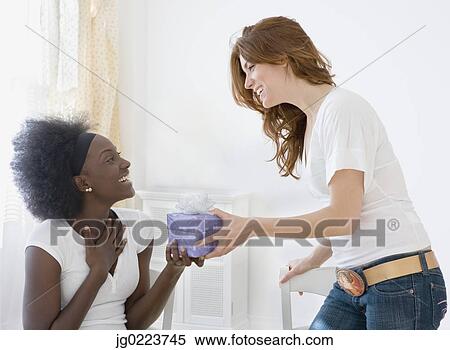 Two women exchanging gifts View Large Photo Image Stock Photography - Two women exchanging gifts. Fotosearch
