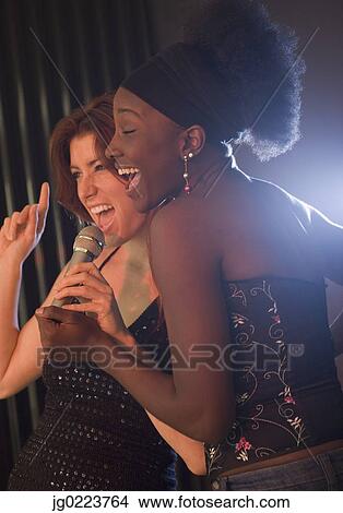 Two women singing in nightclub View Large Photo Image Picture - Two women singing in nightclub. Fotosearch