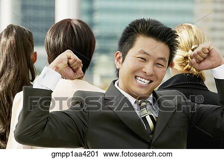 Stock Image - Young Asian businessman cheering. Fotosearch