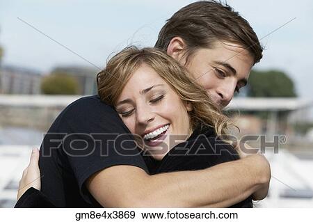 Young Hispanic couple hugging indoors View Large Photo Image Stock Photo - Young Hispanic couple hugging indoors. Fotosearch