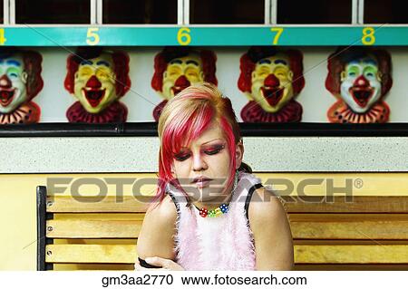 Young Hispanic punk female sitting in front of carnival booth View Large Photo Image Stock Image - Young Hispanic punk female sitting in front of carnival booth. Fotosearch
