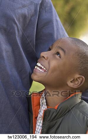African boy smiling up at parent View Large Photo Image Picture - African boy smiling up at parent. Fotosearch