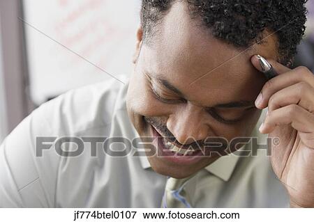 African businessman looking down View Large Photo Image Stock Photo - African businessman looking down. Fotosearch