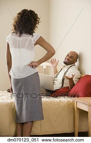 African businessman shrugging shoulders at wife View Large Photo Image Stock Image - African businessman shrugging shoulders at wife. Fotosearch
