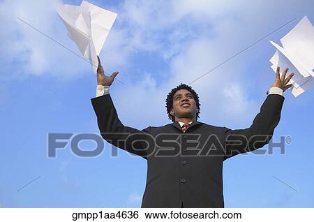African businessman throwing papers in air View Large Photo Image Stock Photograph - African businessman throwing papers in air. Fotosearch