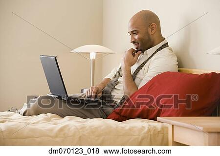 African businessman typing on laptop View Large Photo Image Stock Photo - African businessman typing on laptop. Fotosearch