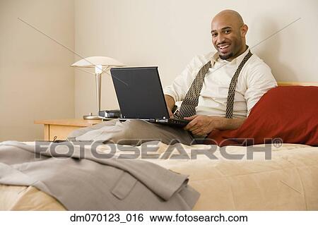 African businessman typing on laptop View Large Photo Image Stock Photograph - African businessman typing on laptop. Fotosearch