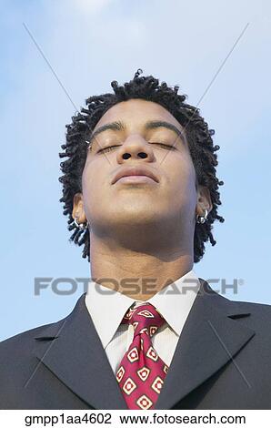 African businessman with eyes closed View Large Photo Image Stock Image - African businessman with eyes closed. Fotosearch