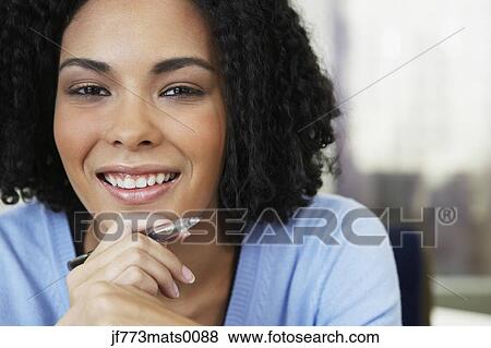 Stock Photo - African businesswoman holding pen. Fotosearch