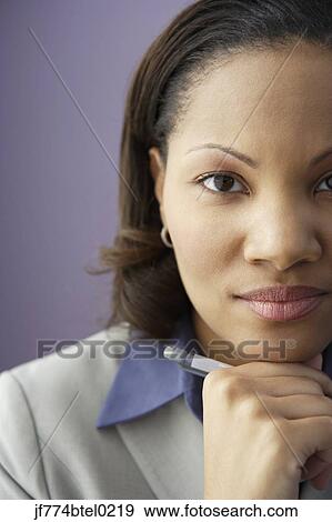 African businesswoman holding pen View Large Photo Image Stock Photo - African businesswoman holding pen. Fotosearch