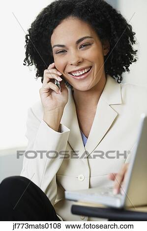 Stock Photo - African businesswoman talking on cell phone. Fotosearch