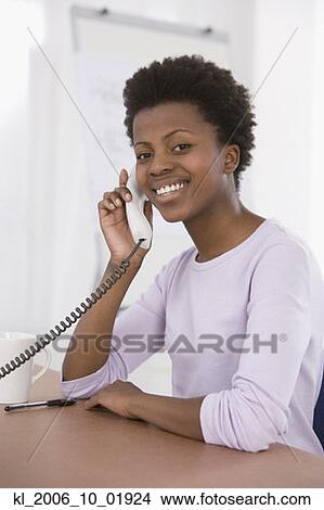 African businesswoman talking on telephone View Large Photo Image Picture - African businesswoman talking on telephone. Fotosearch