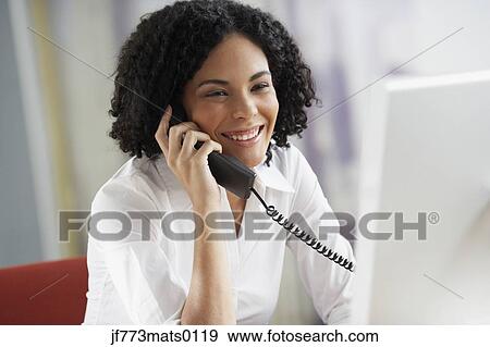 African businesswoman talking on telephone View Large Photo Image Stock Photo - African businesswoman talking on telephone. Fotosearch