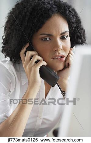 Stock Photograph - African businesswoman talking on telephone. Fotosearch