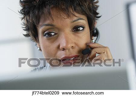African businesswoman wearing headset View Large Photo Image Stock Photo - African businesswoman wearing headset. Fotosearch