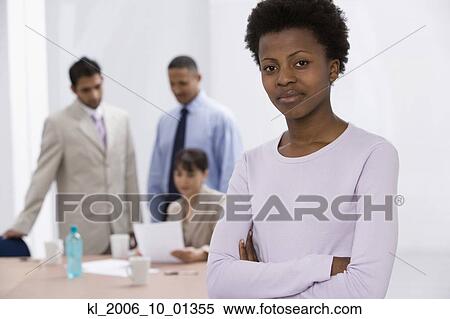 African businesswoman with co-workers in background View Large Photo Image Stock Photography - African businesswoman with co-workers in background. Fotosearch