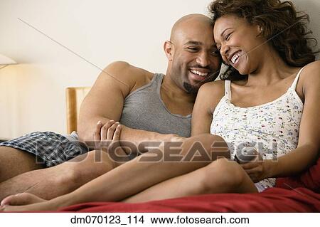 African couple cuddling in bed View Large Photo Image Picture - African couple cuddling in bed. Fotosearch