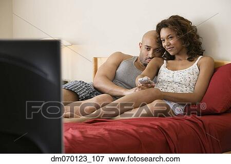 African couple cuddling in bed View Large Photo Image Stock Photo - African couple cuddling in bed. Fotosearch