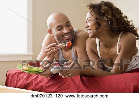 African couple eating in bed View Large Photo Image Stock Image - African couple eating in bed. Fotosearch