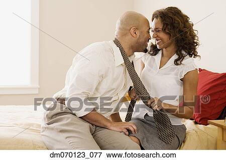 African couple smiling at each other on bed View Large Photo Image Stock Photo - African couple smiling at each other on bed. Fotosearch