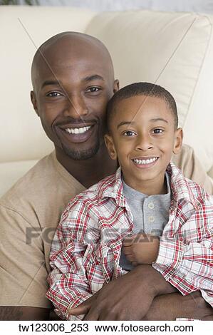 Stock Image - African father and son hugging. Fotosearch
