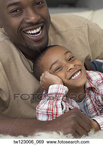 African father and son hugging View Large Photo Image Stock Photo - African father and son hugging. Fotosearch