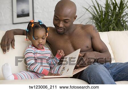 African father reading to daughter View Large Photo Image Stock Image - African father reading to daughter. Fotosearch