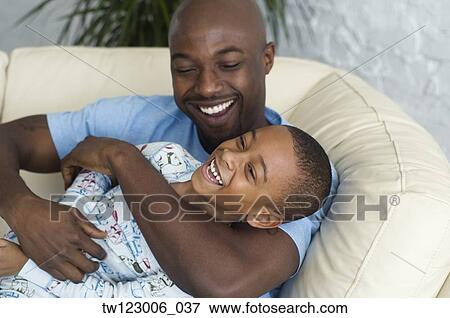 African father tickling son View Large Photo Image Stock Photo - African father tickling son. Fotosearch