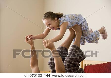 African girl balancing on father’s feet View Large Photo Image Picture - African girl balancing on father’s feet. Fotosearch