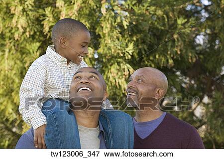 Stock Photo - African grandfather, father and son in park. Fotosearch