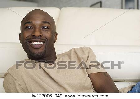 African man sitting on floor View Large Photo Image Stock Photo - African man sitting on floor. Fotosearch