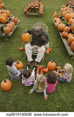 African man talking to children about pumpkins View Large Photo Image Stock Photograph - African man talking to children about pumpkins. Fotosearch