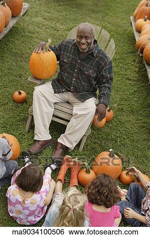 African man talking to children about pumpkins View Large Photo Image Stock Photograph - African man talking to children about pumpkins. Fotosearch