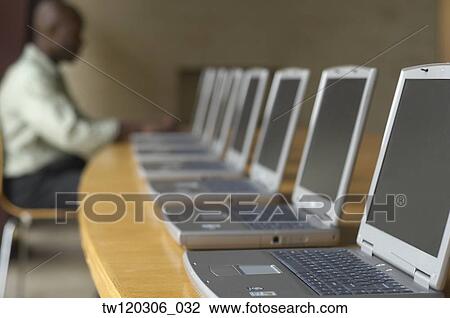 African man using laptop at computer lab View Large Photo Image Stock Image - African man using laptop at computer lab. Fotosearch