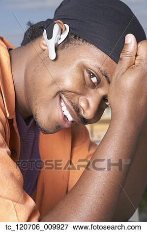 African man wearing hands free device View Large Photo Image Stock Photo - African man wearing hands free device. Fotosearch