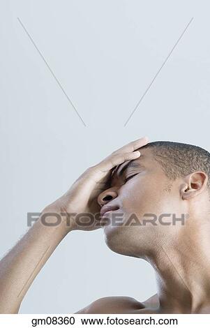 Stock Image - African man with hand on head. Fotosearch