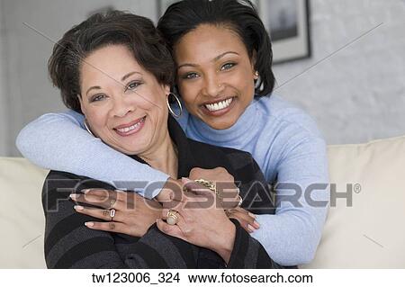 African mother and adult daughter hugging View Large Photo Image Picture - African mother and adult daughter hugging. Fotosearch