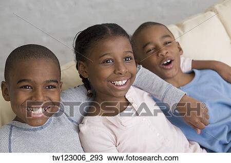 African siblings laughing on sofa View Large Photo Image Stock Image - African siblings laughing on sofa. Fotosearch