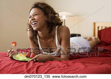 African woman eating in bed View Large Photo Image Stock Photography - African woman eating in bed. Fotosearch