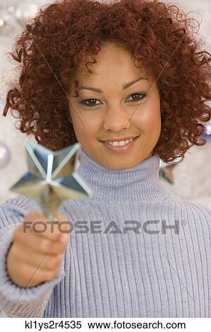 African woman holding Christmas ornament View Large Photo Image Stock Photography - African woman holding Christmas ornament. Fotosearch