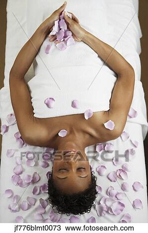 African woman laying on spa table View Large Photo Image Stock Image - African woman laying on spa table. Fotosearch