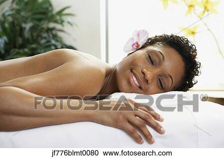 African woman laying on spa table View Large Photo Image Stock Image - African woman laying on spa table. Fotosearch
