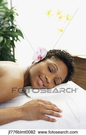 African woman laying on spa table View Large Photo Image Stock Image - African woman laying on spa table. Fotosearch